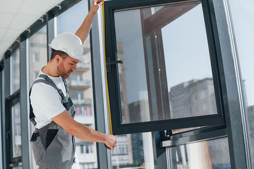 Commercial glazier installing glass windows on the Gold Coast